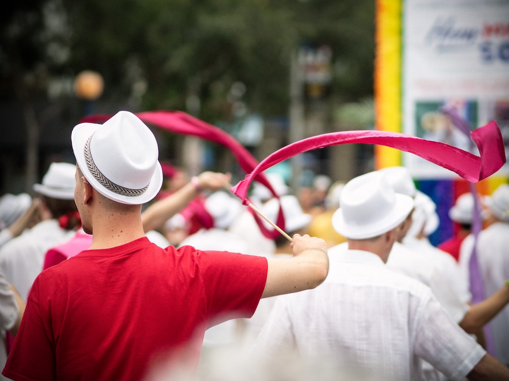 men in a crowd with white hats on