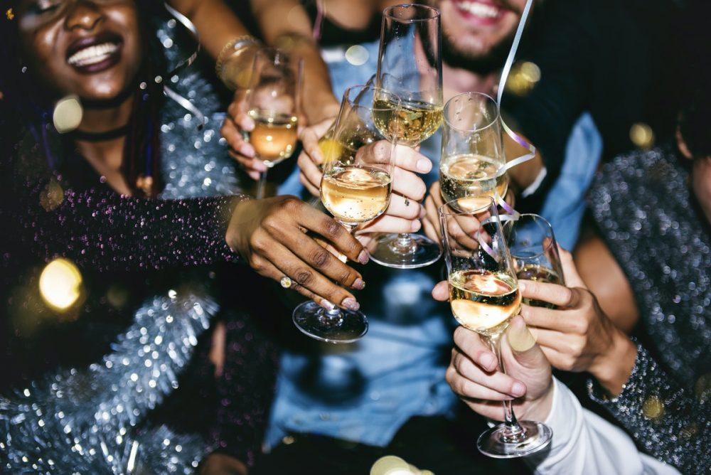 group of people celebrating with wine