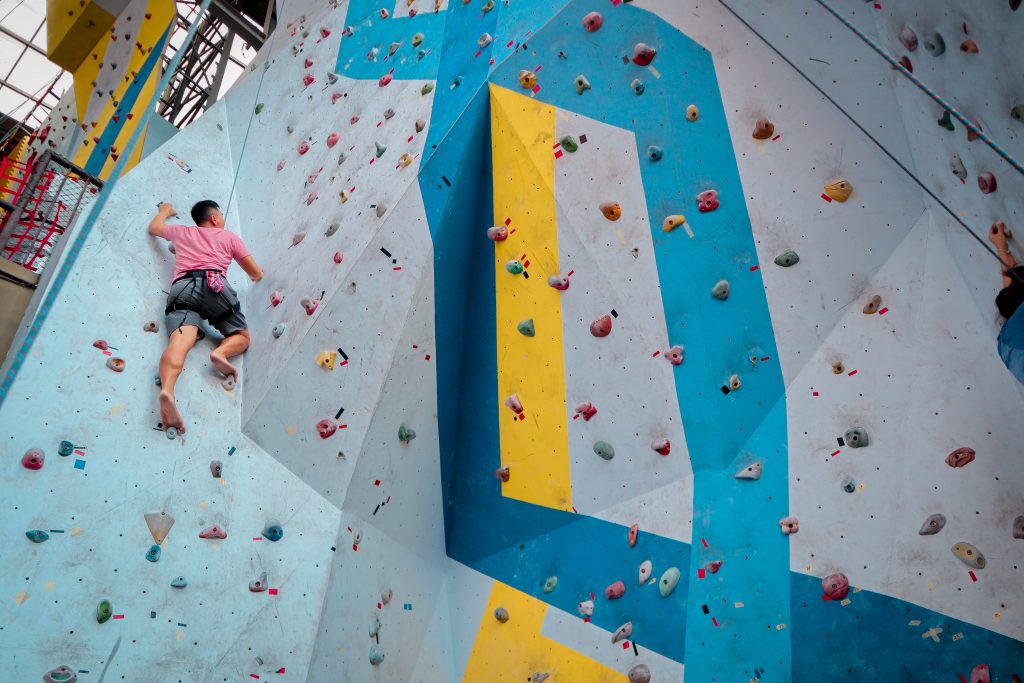 person using a rock climbing wall indoors