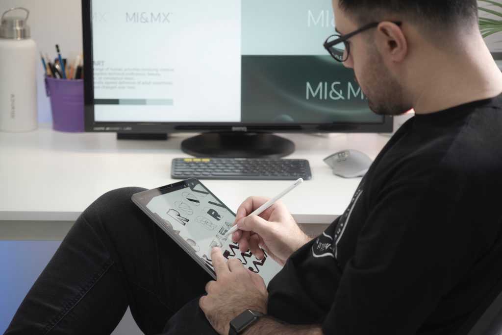 man designing a website on a tablet