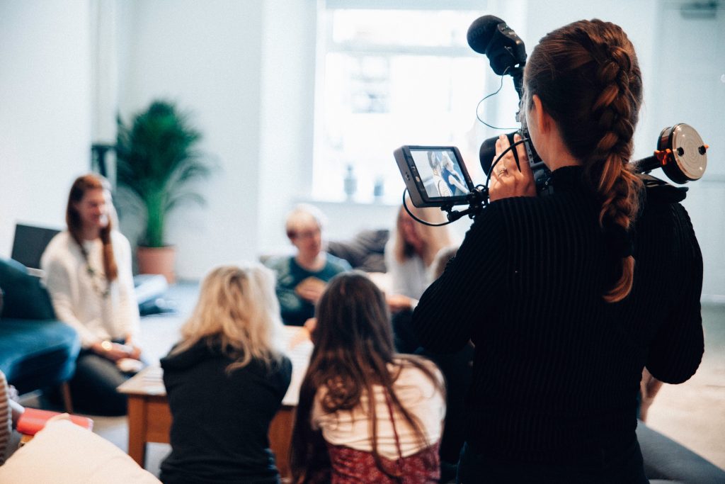 women videotaping a group of women