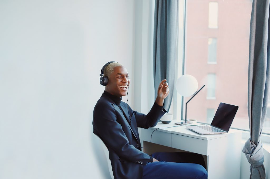 man working remotely on the phone laughing