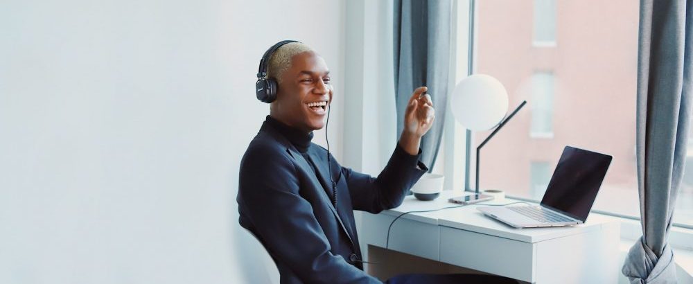 man working remotely on the phone laughing