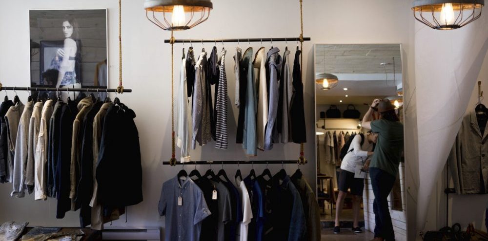 interior of a men's clothing store with racks of clothes