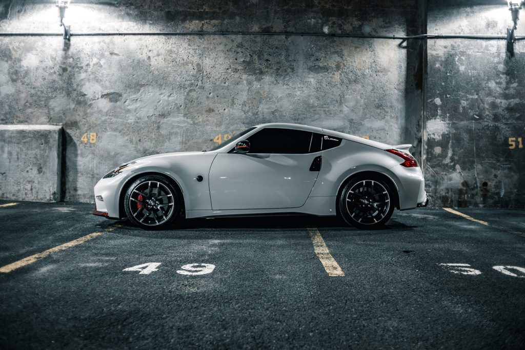 automotive marketing image of a white sports car in a parking garage