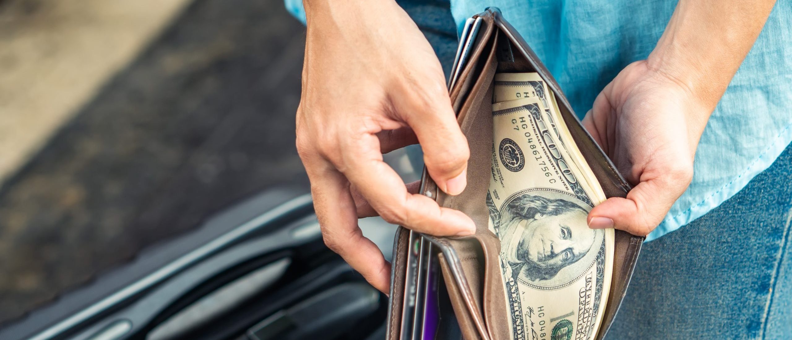 Wallet with hundred dollar bills inside