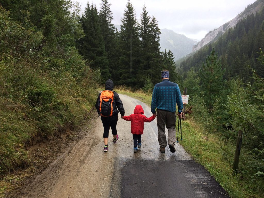 family hiking outdoors with small child