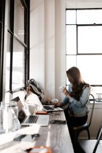 woman working on her laptop at a coffee shop