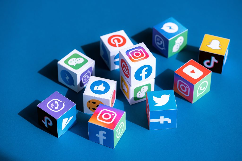 dice with social media logos against a blue background