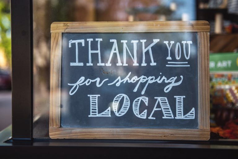 chalkboard sign that reads "thank you for shopping local"