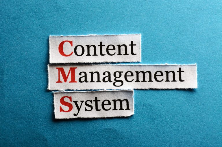 CMS Content Management System abbreviation on blue paper