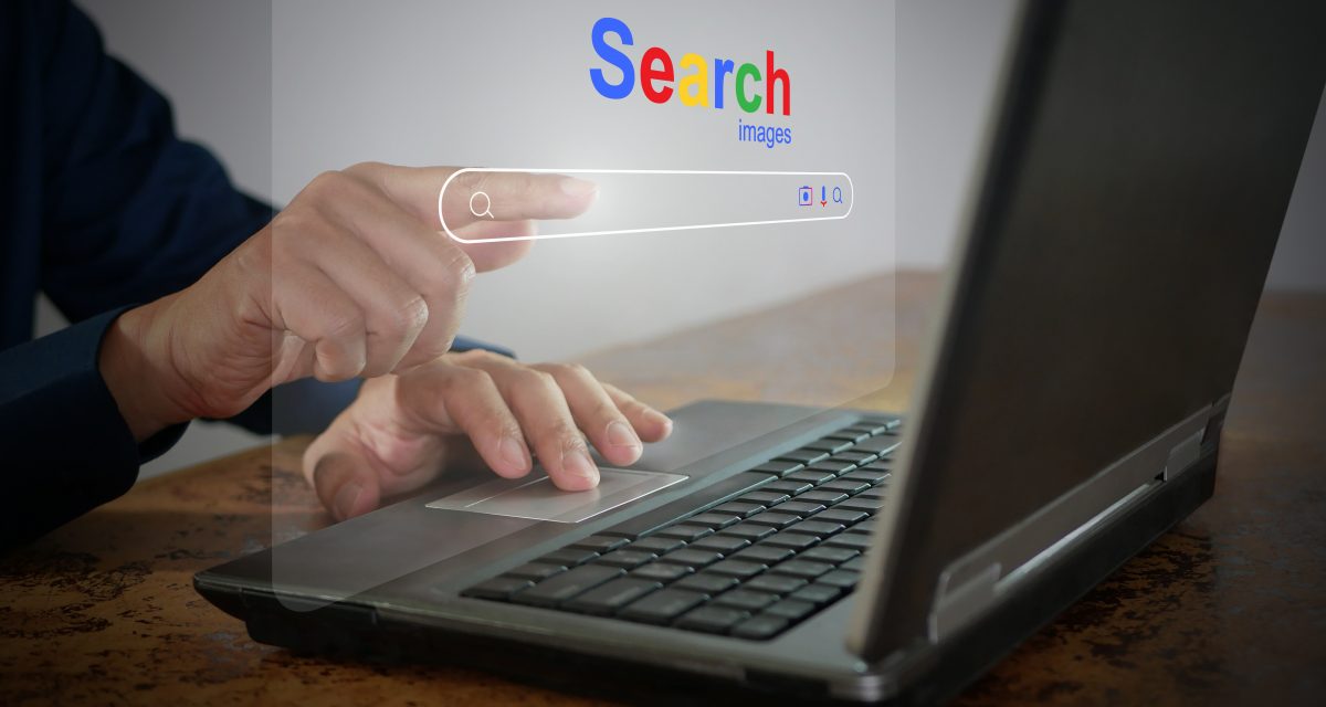 A man is using a notebook computer to searching for information. A virtual screen of the Search website browser for finding data on the internet. Global network, search engine optimization technology