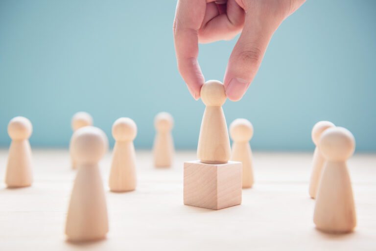 Successful team leader, Businessman hand choose people standing out from the crowd.